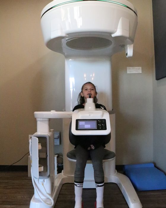 A child being positioned in the 3D CBCT scanner for an airway evaluation
