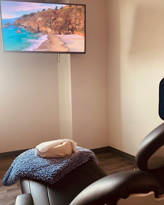 A treatment chair set with a warm blanket for a comfortable, sedation-friendly visit