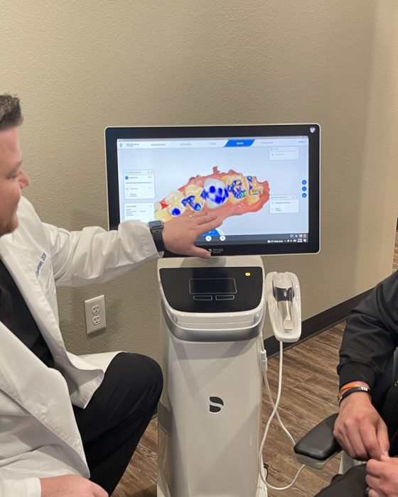 A dentist and patient reviewing a digital smile design together on screen