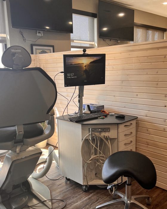 A clean, modern operatory with a chairside monitor at Valley Family Dental